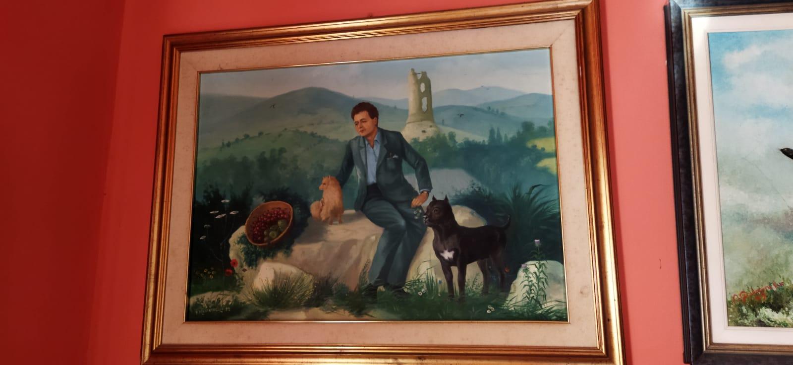 Gifted painting portraying Dott. Flavio Bruno with a Cane Corso in a landscape setting.